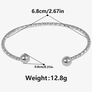 Detail view of silver 304 stainless steel open bangle with rhombus texture and ball ends
