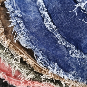 Detail of distressed frayed edges on multi-color washed denim fisherman hats
