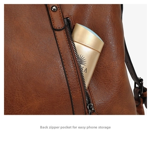 Detailed back view of brown leather tote showing a secure anti-theft zipper pocket