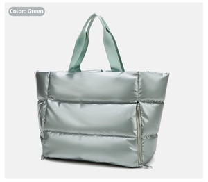Close-up of light green quilted fitness tote bag with metallic finish and zipper details
