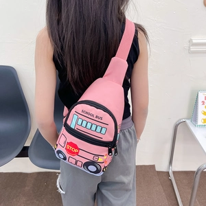 Pink school bus shaped kids chest bag with adjustable strap shown on a model