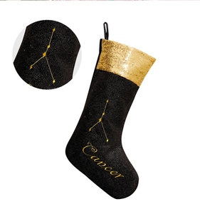Detail of black and gold Cancer zodiac Christmas stocking with sequins and embroidery