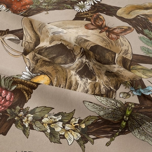 Close-up of bohemian tapestry fabric texture with skull, butterfly and flower prints