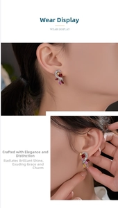 Detail view of multicolored gemstone earrings in a flowing S-shape on a model ear