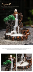 Macro view of zen mountain backflow incense burner with resin pine tree and smoke flow