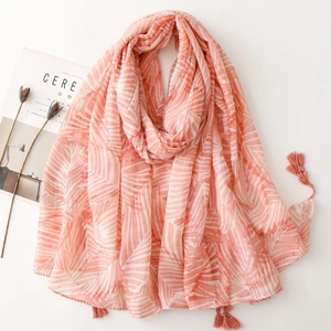 Detail of pink and white leaf pattern scarf with soft tassels and breathable fabric
