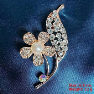 Macro shot of camellia brooch detailing 6.8cm size with rose gold petals and white pearls