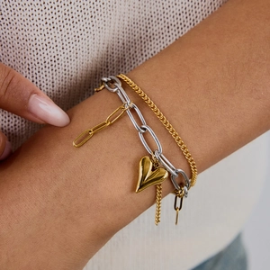 Luxurious layered gold and silver heart pendant chain bracelet for women on wrist
