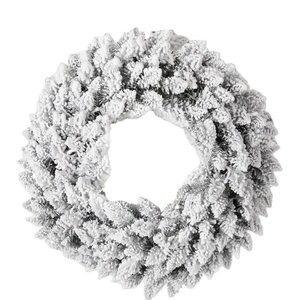 Minimalist white flocked Christmas wreath with heavy snow effect for festive front door decor