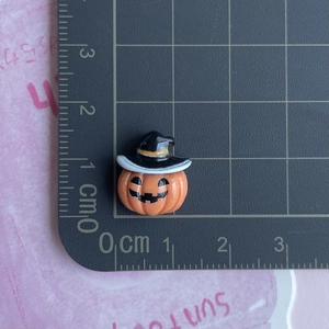 Miniature Halloween pumpkin wizard resin charm showing 1.3cm size detail on cutting mat