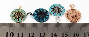 Macro detail of 15mm round starburst charms in four metal finishes with a size scale