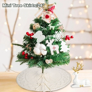 Detail of 24 inch white knitted Christmas tree skirt with festive reindeer decor