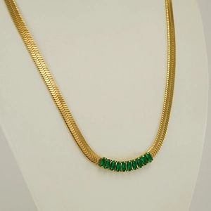 Golden blade snake chain necklace with green zircon stones on female mannequin