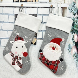 Christmas stockings set with Santa and Reindeer hanging on fireplace for festive decor