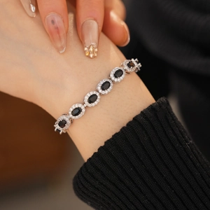 Macro view of adjustable silver bracelet with oval black stones and sparkling zircon pavé