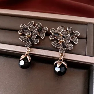 Vintage floral drop earrings with black crystals and faceted beads on leather