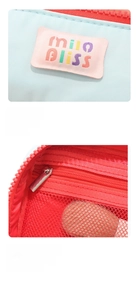 Detail of blue cosmetic bag with red contrast zipper and breathable mesh inner pocket