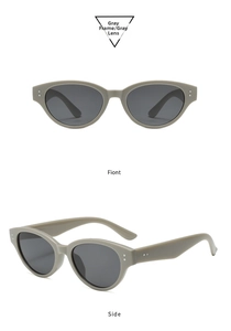 Detailed views of gray cat-eye sunglasses with wide temples and silver rivet decorations
