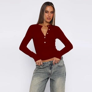 Detail of the ribbed texture and button placket on a burgundy slim fit long sleeve top