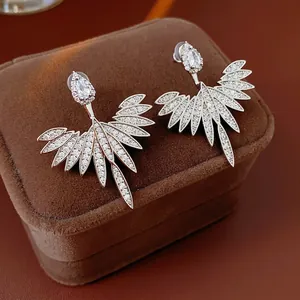 Silver needle stud earrings with zircon leaf drop design in a luxury velvet jewelry box