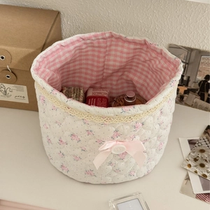 Quilted floral lace storage basket with pink gingham lining and a ribbon bow detail