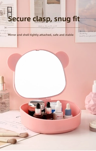 Pink bear desktop makeup mirror with storage tray showing skincare items and brushes