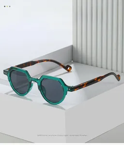 Detail view of green translucent geometric sunglasses with tortoiseshell temples
