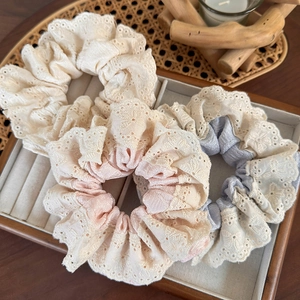 Lace and fabric hair scrunchies in cream white, pink, and blue gradients for women