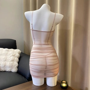 Close-up of ruched champagne mesh bodycon dress with delicate spaghetti straps