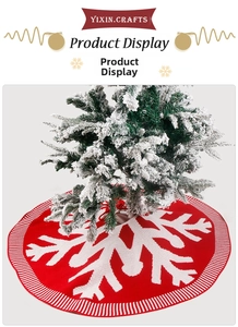 Close-up of red knitted Christmas tree skirt with white snowflake and striped edge