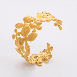 18k gold plated stainless steel open bangle featuring intricate matte floral patterns