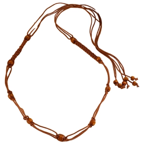 Detail of handcrafted bohemian waist chain with brown braided cotton rope and wooden beads