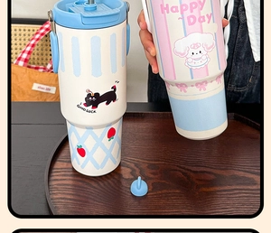 Detailed view of the large insulated tumbler featuring a cute cartoon sheep and carry handle