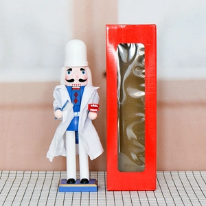 Dentist nutcracker wooden puppet in doctor coat with toothbrush and window gift box