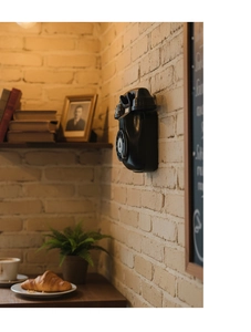 Detail of vintage wall-mounted rotary telephone model with industrial retro aesthetic