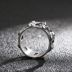 Macro shot of vintage silver-tone skeleton skull embossed ring with gothic oxidation details
