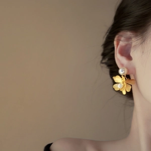 Elegant gold flower earrings with pearls shown on model for a vintage French style