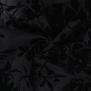 Macro detail of black flocked lace fabric with floral patterns and mesh texture