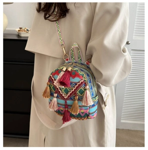 Close-up of ethnic woven backpack with colorful tassels and patterned shoulder straps