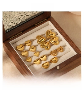 Polished 18k gold plated heart earrings set displayed in a premium wooden jewelry gift box