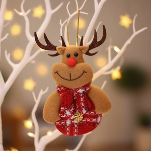 Christmas reindeer plush ornament with red plaid scarf hanging on a festive branch