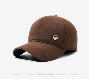 Close-up of brown wool baseball cap featuring a metal 'Fashion' plaque and fabric texture