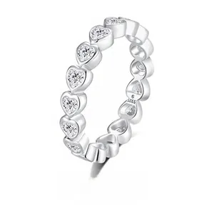 Macro detail of S925 sterling silver ring band with heart-shaped claw-set stones
