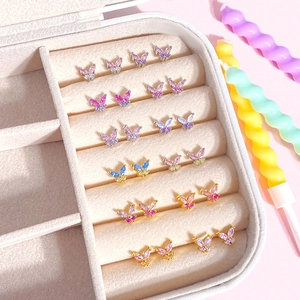 Macro view of butterfly stud earrings set with colorful cubic zirconia in a jewelry box