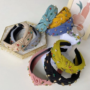 Group display of knotted fabric headbands with multi-color rhinestones in assorted colors