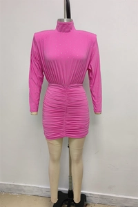 Detail of pink turtleneck mini dress featuring sparkling rhinestones and ruched textures