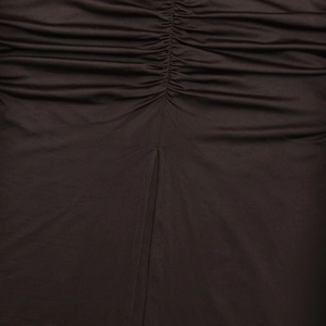 Detailed close-up of dark brown stretch fabric with ruched texture and vertical stitching