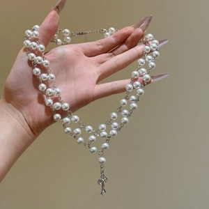 Double-layered pearl necklace featuring a silver zircon cross pendant in vintage gothic style