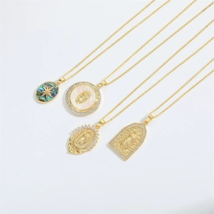 Detailed close-up of gold Virgin Mary pendants with mother of pearl and cubic zirconia
