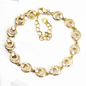 Macro detail of gold-plated chain bracelet with micro-pave zircons and lobster clasp